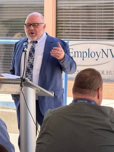Milt Stewart speaking at a podium outside the EmployNV career hub