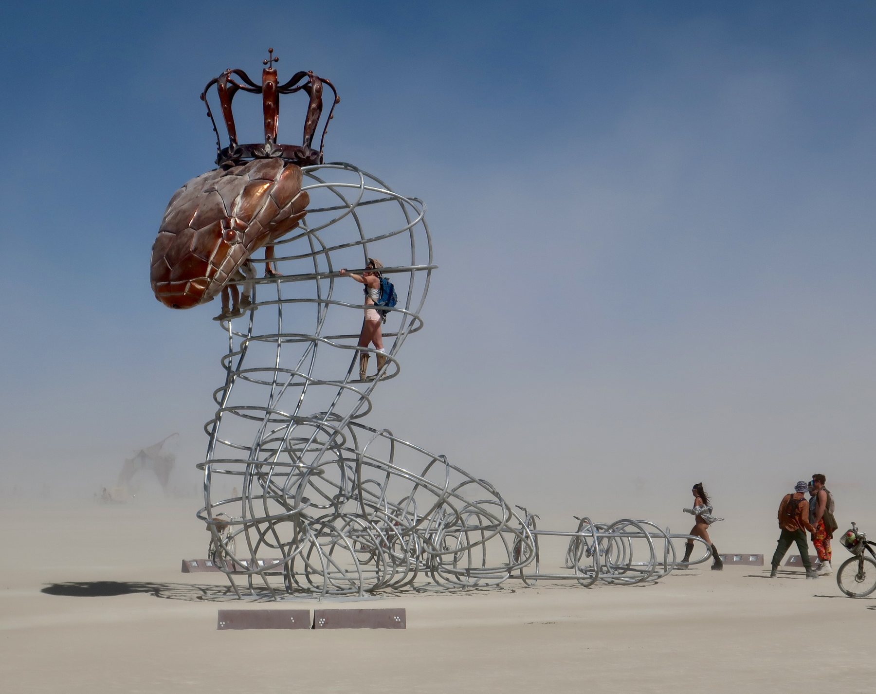 Queen Cobra, a 25 foot steel and copper snake sculpture with a crown, on the playa at Burning Man
